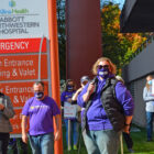 Judy Grack standing and speaking at a rally outside hospital