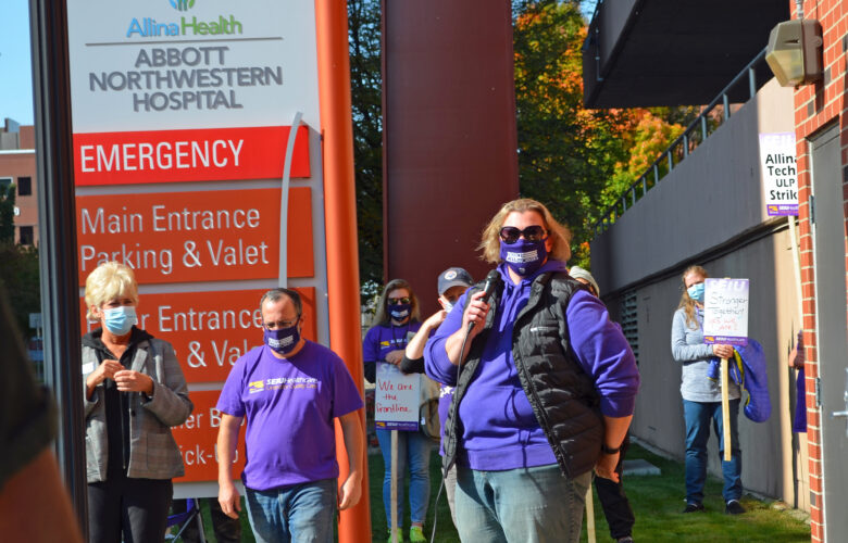 Judy Grack standing and speaking at a rally outside hospital