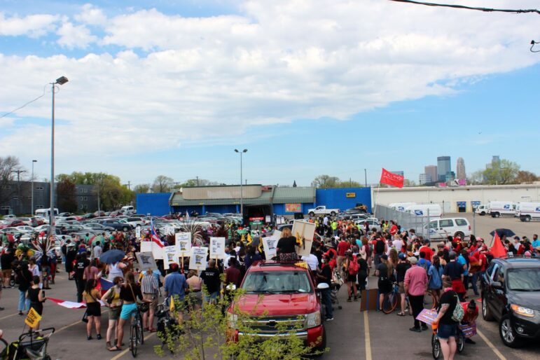 a large crowd is assembled in a parking lot