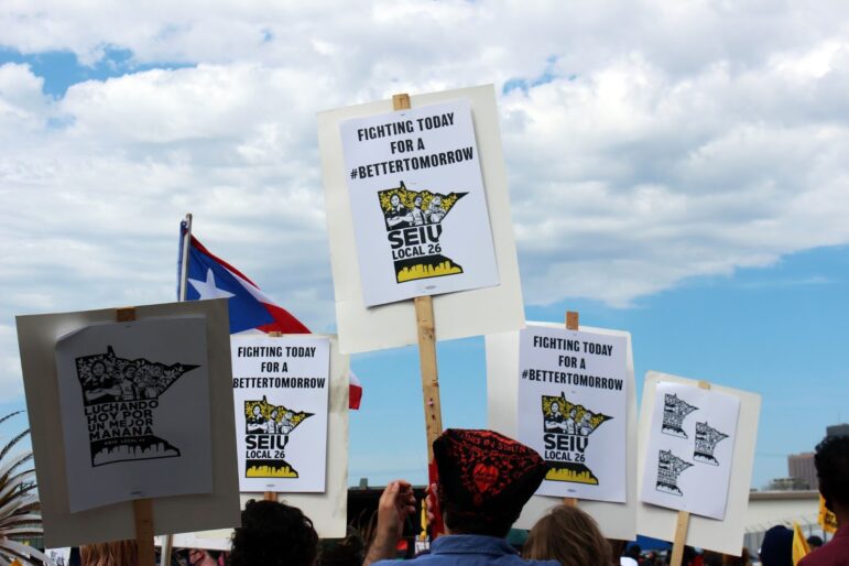 signs reading "fighting today for a better tomorrow SEIU local 26"