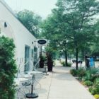 the front of birchwood cafe, including a sign on the top left, metal chairs stacked up on the left