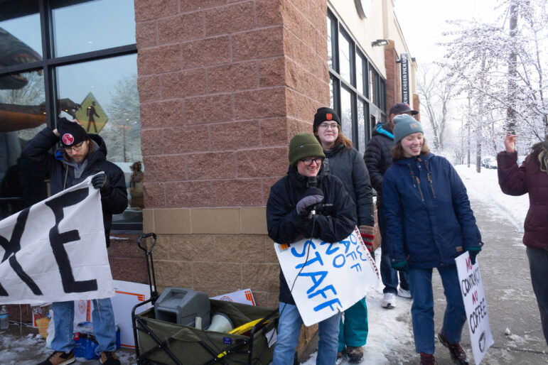 Ethan Carlson, Starbucks barista, holding a sign at a picket line outside Starbucks in St. Paul, Minnesota. 