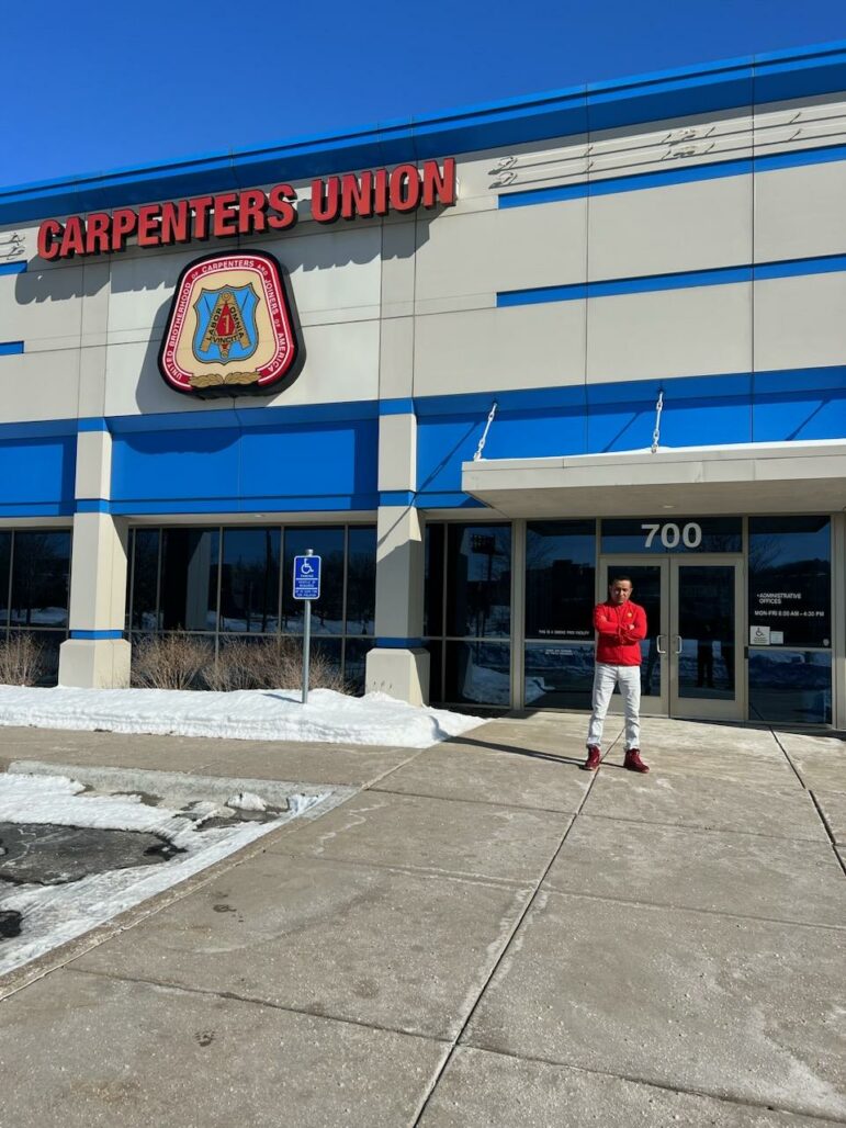 Francisco Lozano standing in front of the Carpenters Union hall in St. Paul, Minn.