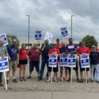 Eric McAleavey, (sixth from right) and other workers at the General Motors’ Hudson Parts Distribution Center in Wisconsin picket outside the facility on Sept, 22, 2023. They were among 38 parts distribution centers called out on Friday to escalate UAW’s ”stand-up strike” against the Big Three Automakers.