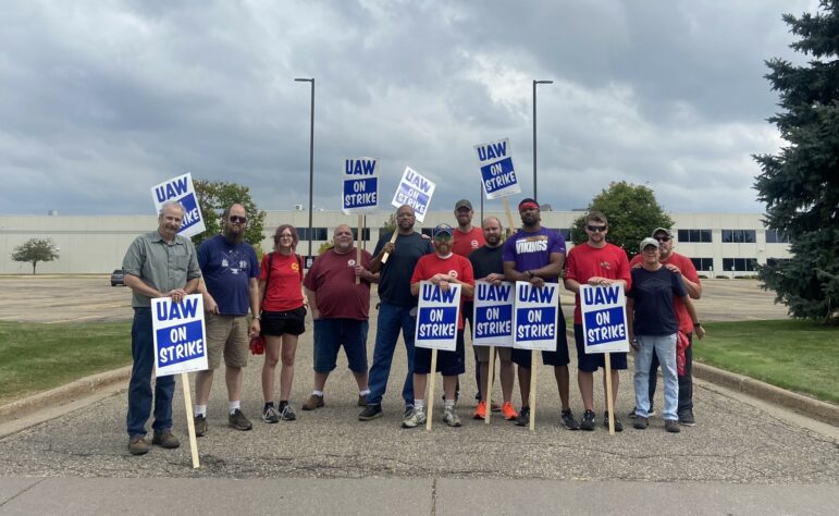 Eric McAleavey, (sixth from right) and other workers at the General Motors’ Hudson Parts Distribution Center in Wisconsin picket outside the facility on Sept, 22, 2023. They were among 38 parts distribution centers called out on Friday to escalate UAW’s ”stand-up strike” against the Big Three Automakers.