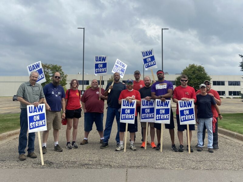 Eric McAleavey, (sixth from right) and other workers at the General Motors’ Hudson Parts Distribution Center in Wisconsin picket outside the facility on Sept, 22, 2023. They were among 38 parts distribution centers called out on Friday to escalate UAW’s ”stand-up strike” against the Big Three Automakers.