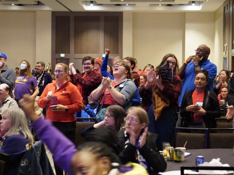 Unions members cheering in a crowd at the "What Could We Win Together" event on October 7.