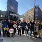 First Avenue workers pose with their fists raised outside the iconic Minneapolis music venue only a few hours before the First Avenue management voluntarily recognized the union.