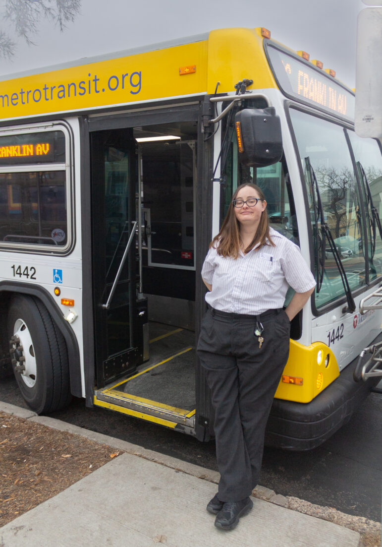 Abigael Ensor, Metro Transit bus operator, stands in front of the 2 bus in Minneapolis. Photo by Isabela Escalona. 