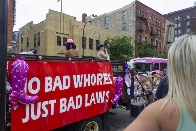 A sign reads, “No Bad Whores, Just Bad Laws”, a call to decriminalize sex work and decrease stigma and end the criminalization of sex workers. 