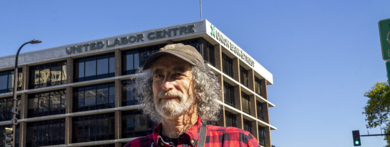 Steve Share poses for a photo in front of the United Labor Center in Minneapolis.