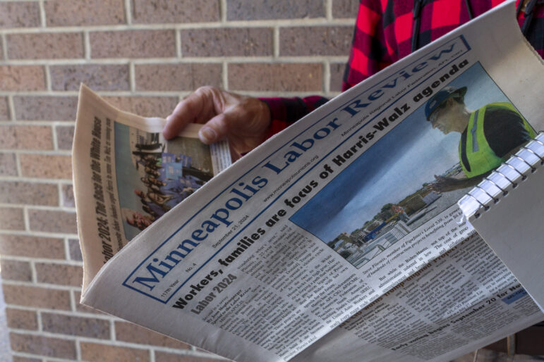 Steve Share holds up a copy of the 'Minneapolis Labor Review'.