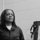 Kira Ross is a member of ATU Local 1005 and Metro Transit’s first black woman mechanic. Ross is photographed while working at the Haywood Garage in Minneapolis, posing next to a tool box. 