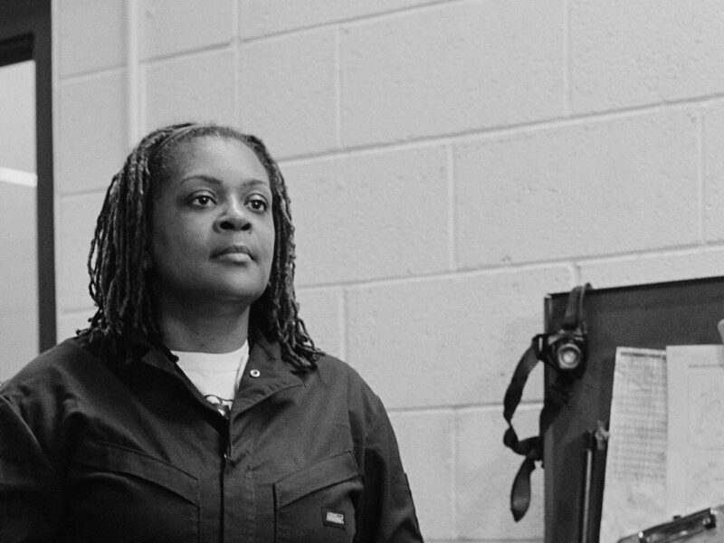 Kira Ross is a member of ATU Local 1005 and Metro Transit’s first black woman mechanic. Ross is photographed while working at the Haywood Garage in Minneapolis, posing next to a tool box. 