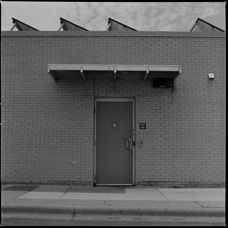 The exhibit also included photographs of the structures that make up public transit and that are integral to workers’ experiences. Pictured above is a bathroom facility for workers in Southdale Center in Edina, Minn.  