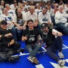 Workers from the Minnesota Timberwolves and Lynx in-house audio visual crew pose for a photo court side.