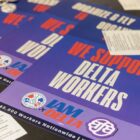 Purple posters with red and white text read "We support Delta Workers" With the IAM and AFA logos