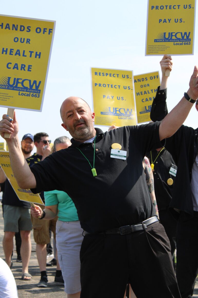 Ryan Christensen, a grocery store worker at Lunds & Byerlys for the past 38 years at a rally.