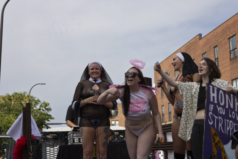 An executive director of the Minneapolis chapter of SWOP MPLS, Andi Snow (left), and other SWOP members lead the march wearing nuns' habits and an angel halo in honor of the parade’s theme, ‘Saints and Sluts’.