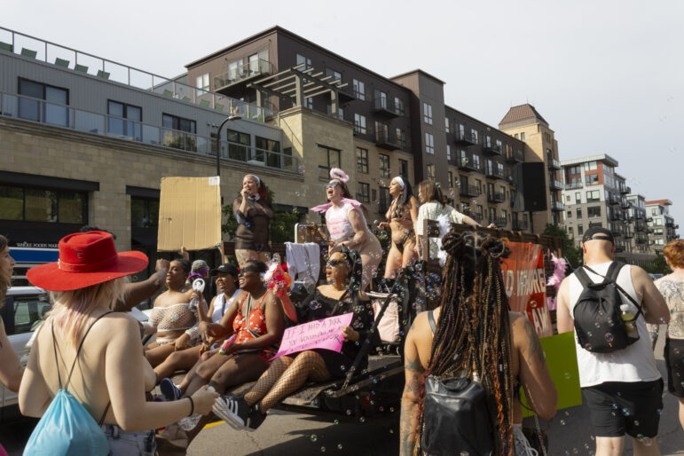 Marchers sing chants and blow bubbles for a festive atmosphere throughout the parade.