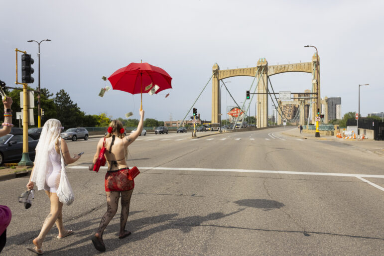 Two marchers lead the pack as the parade makes its way onto the Hennepin Avenue bridge.