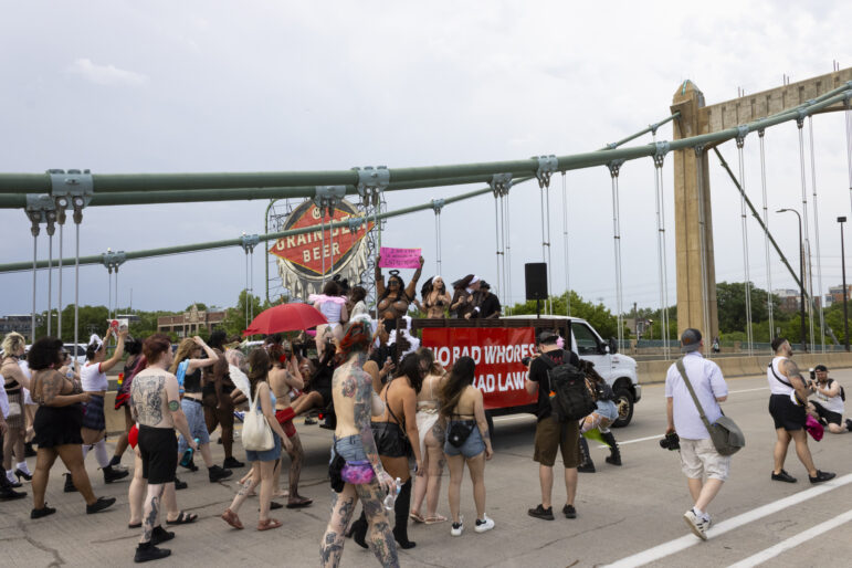 Marchers in front of the iconic ‘Grain Belt Beer’ sign in Minneapolis.